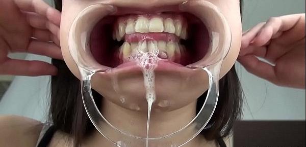  A woman shows her gums and sputs saliva